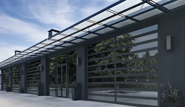 Custom man cave garage build with full-view glass sectional doors and showroom lighting