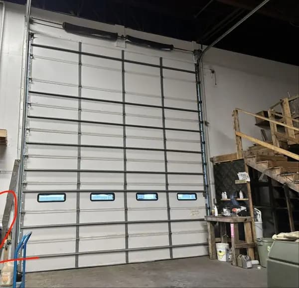 Insulated warehouse sectional door with a row of vision windows